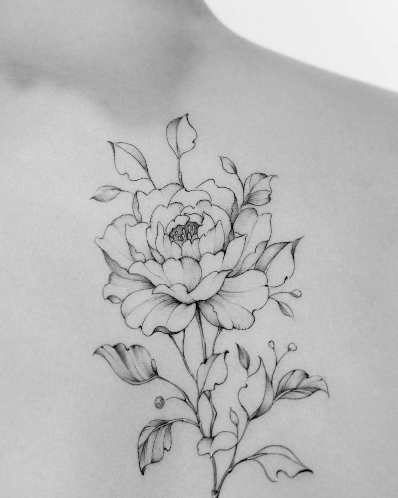 Fine line peony tattoo on the upper back.
