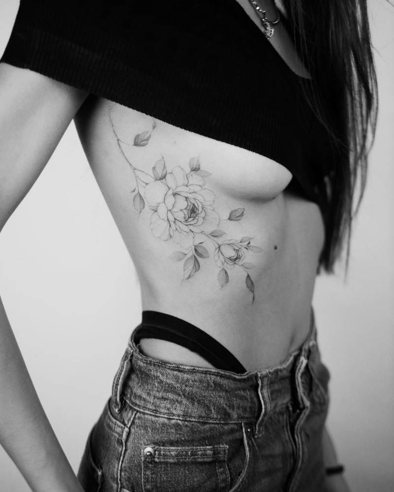 Illustrative style peony tattoo located on the side boob.