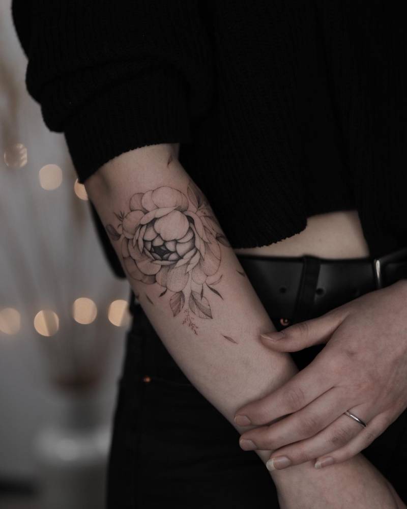 Freehand peony tattoo placed on the forearm.