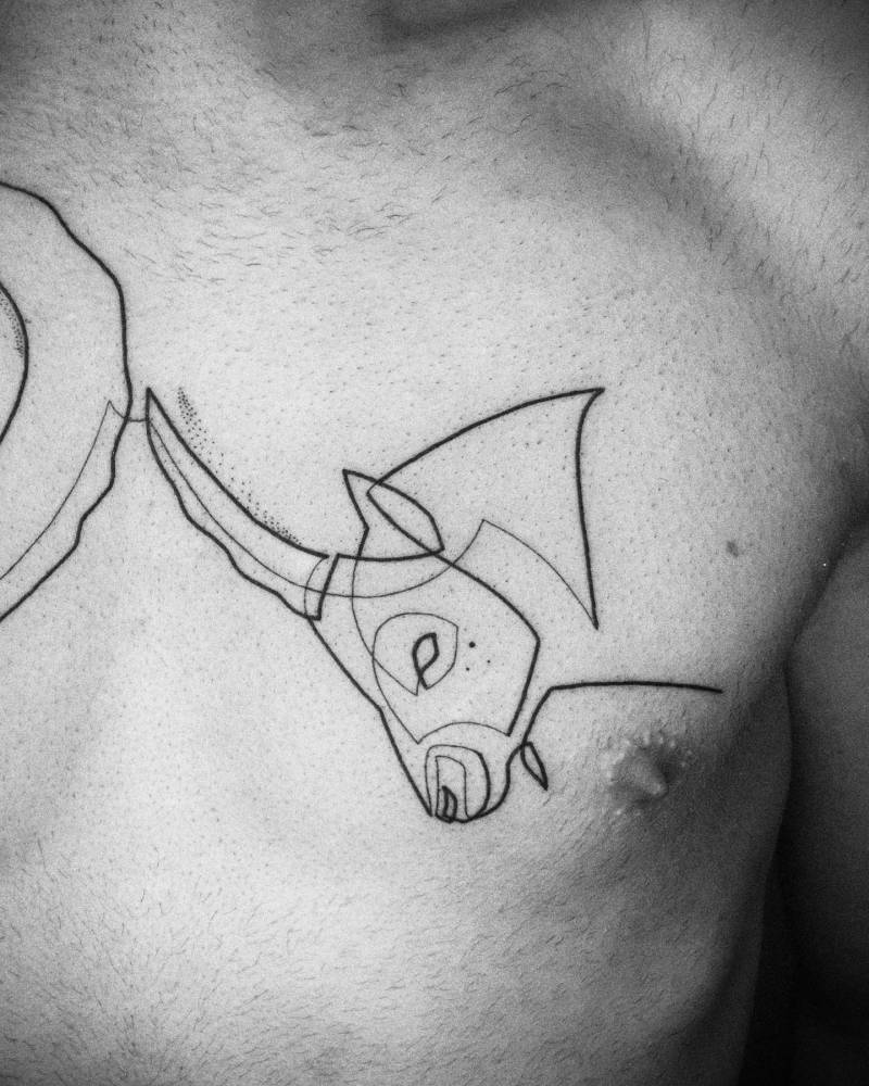 Continuous line goat portrait tattoo located on the chest.