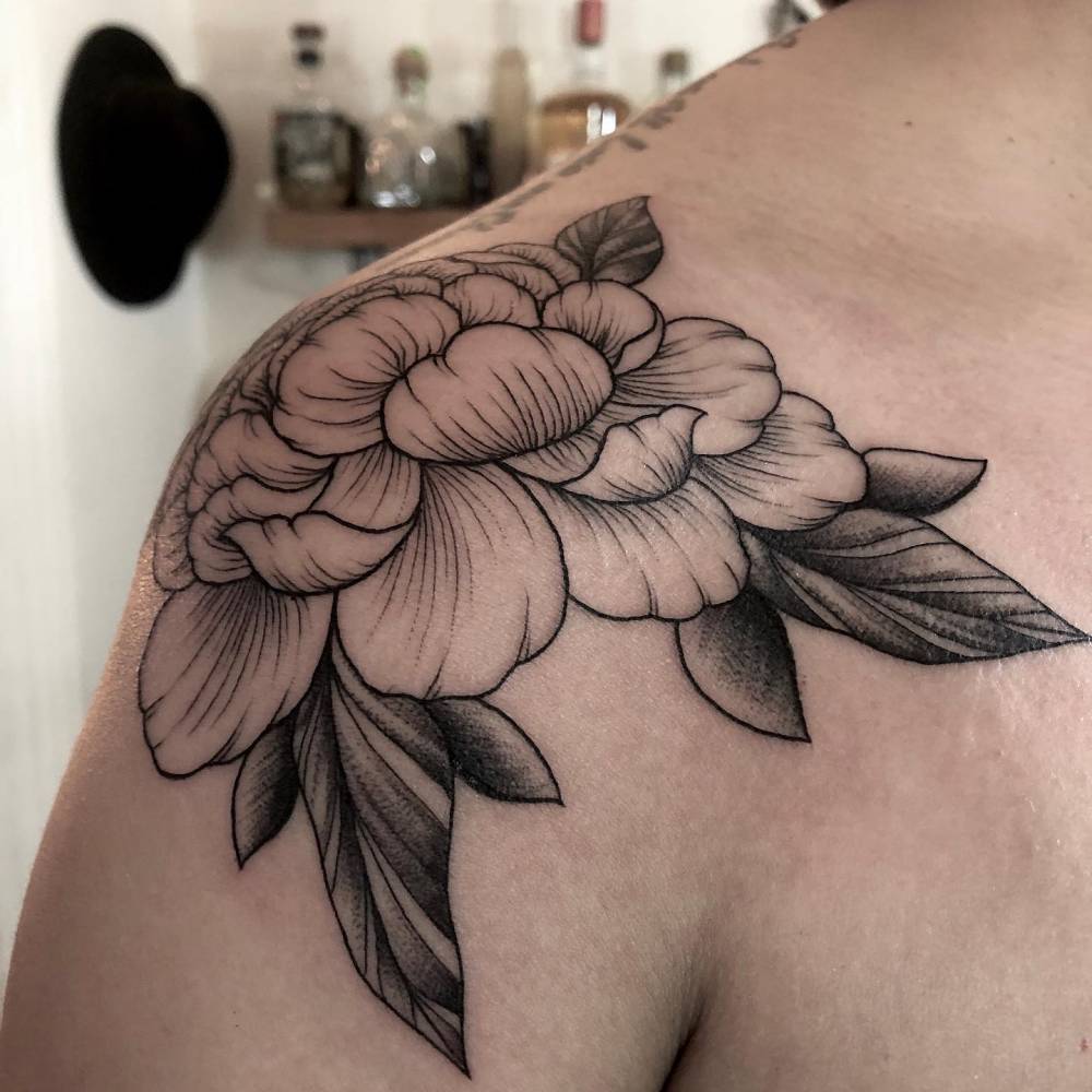 Peony tattoo done on the shoulder.
