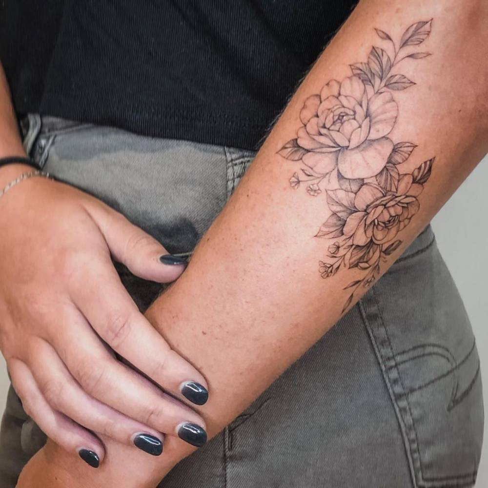 Fine line peonies tattoo on the forearm.