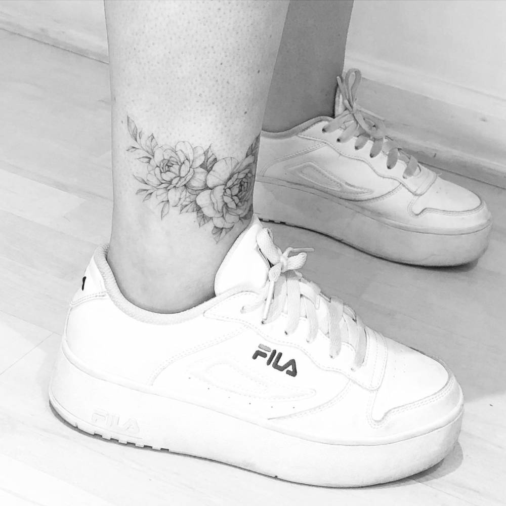 Fine line peonies tattooed on the ankle.