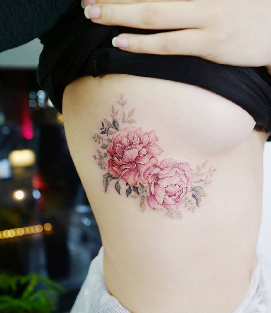 Peonies tattooed on the side boob.