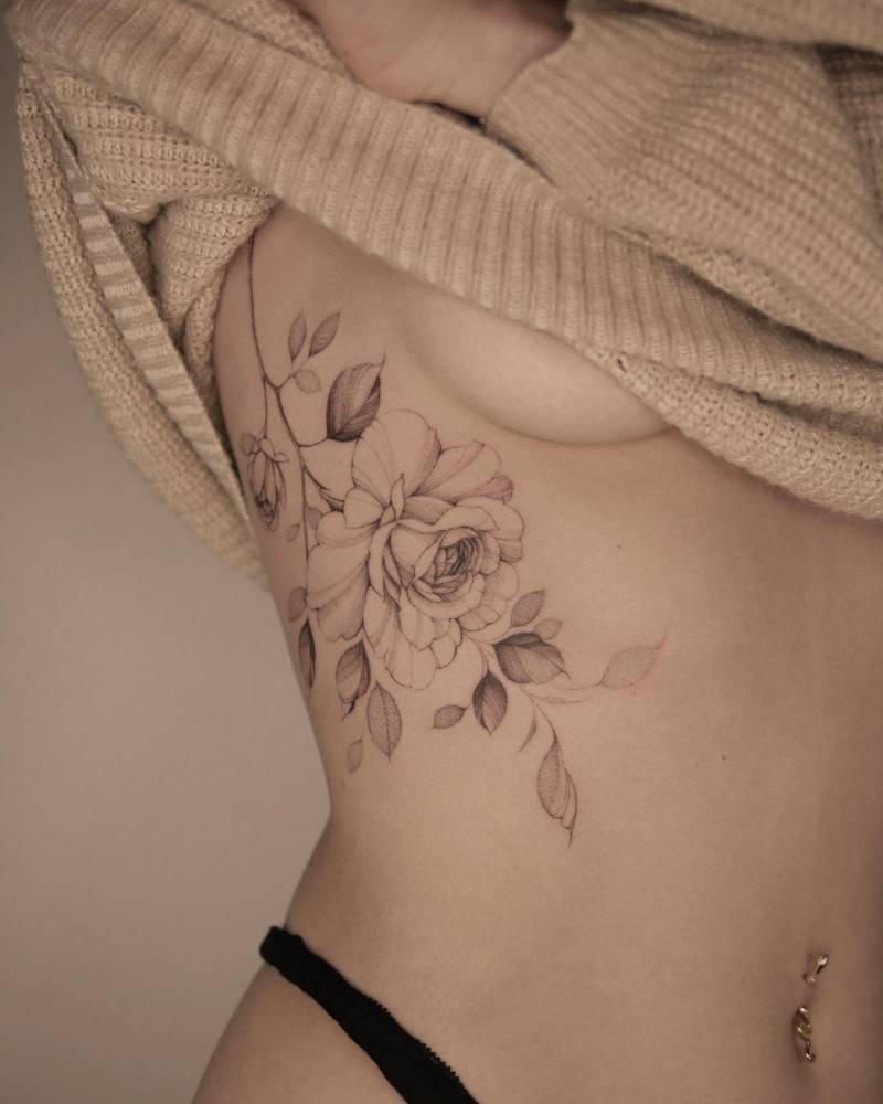Illustrative style peony tattoo located on the rib.