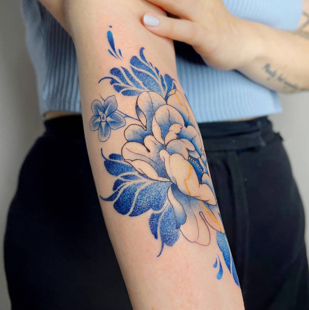 Blue peony kintsugi tattoo done on the inner forearm.