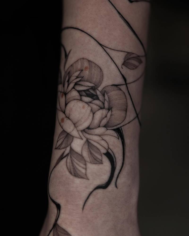 Peony tattoo located on the wrist, illustrative style.