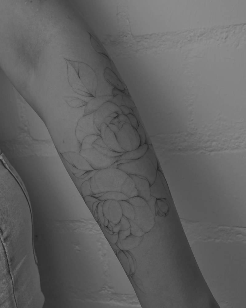 Fine line style peonies tattoo placed on the forearm.