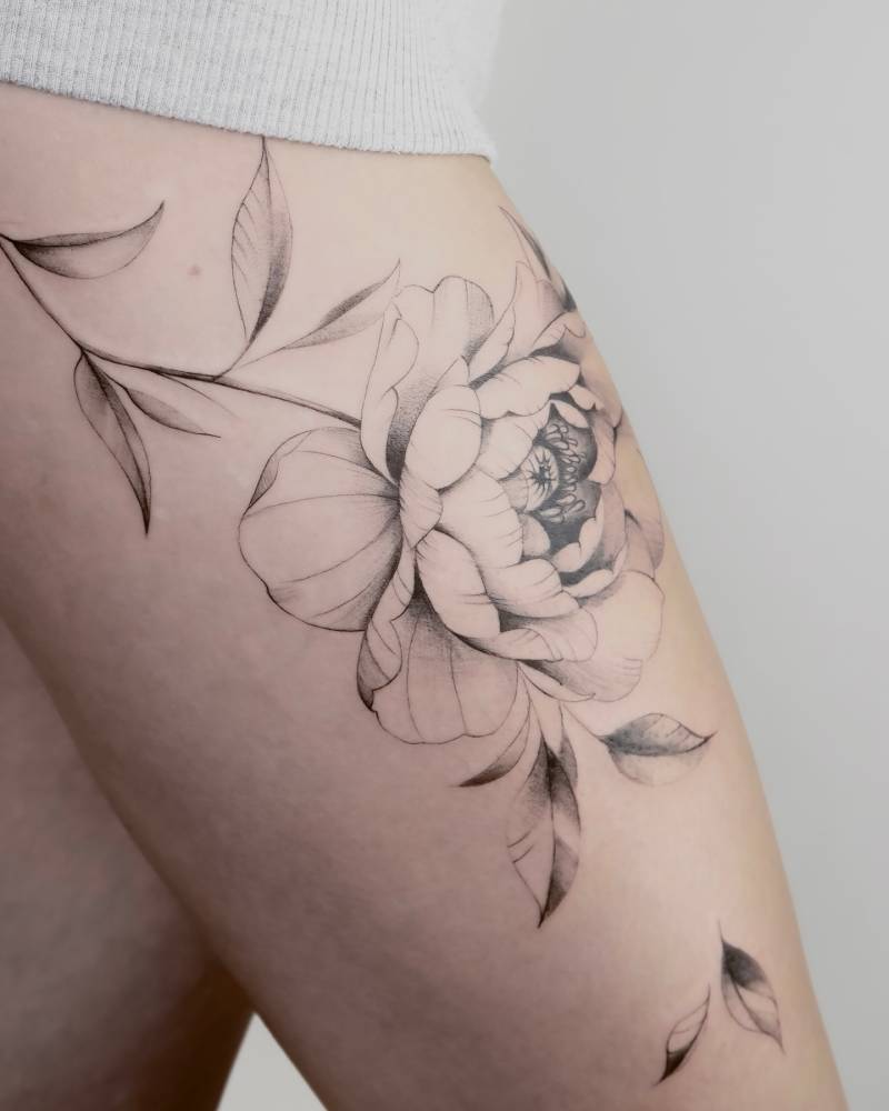 Illustrative style peony tattoo located on the thigh.