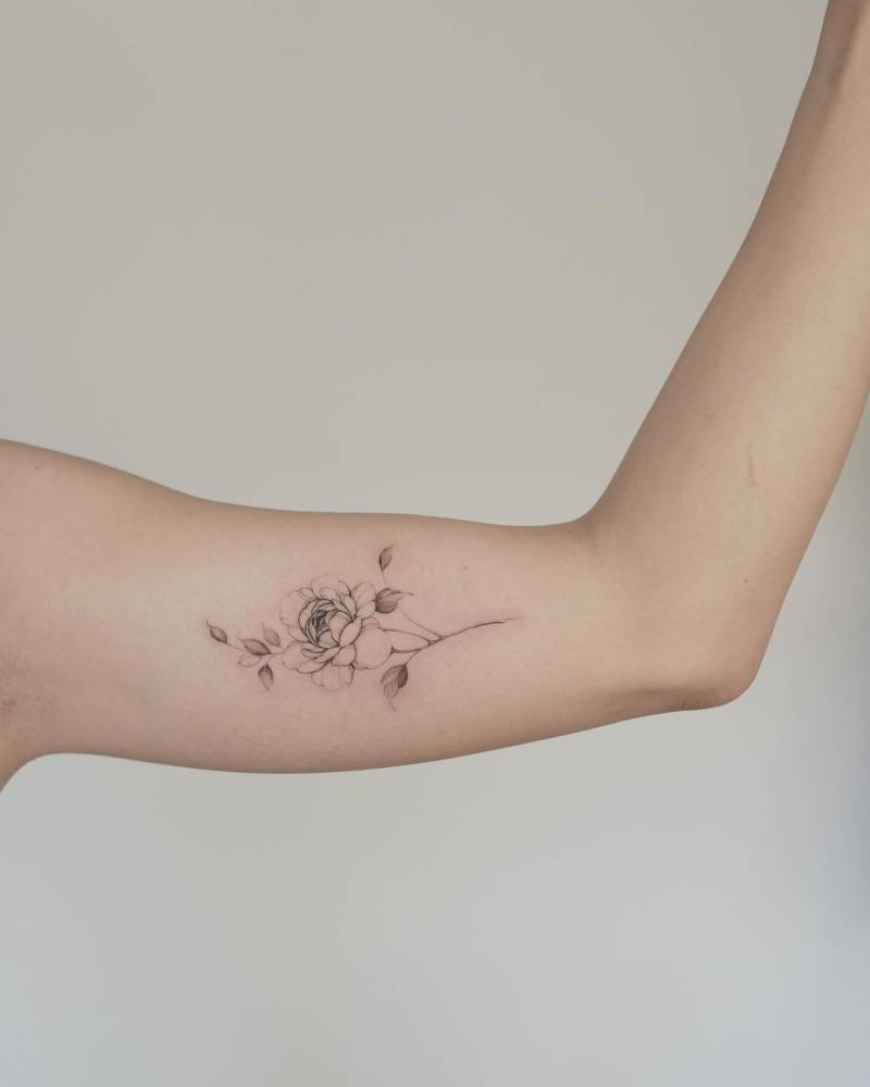 Peony tattoo located on the inner arm, done in illustrative style