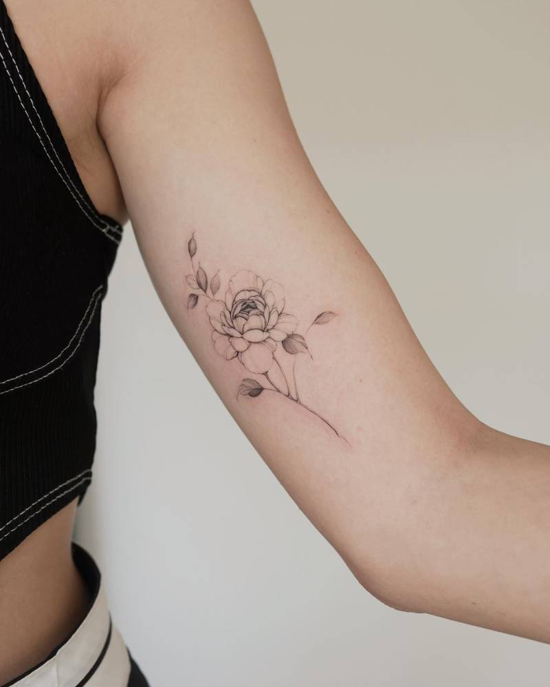 Peony tattoo located on the inner arm, done in illustrative style