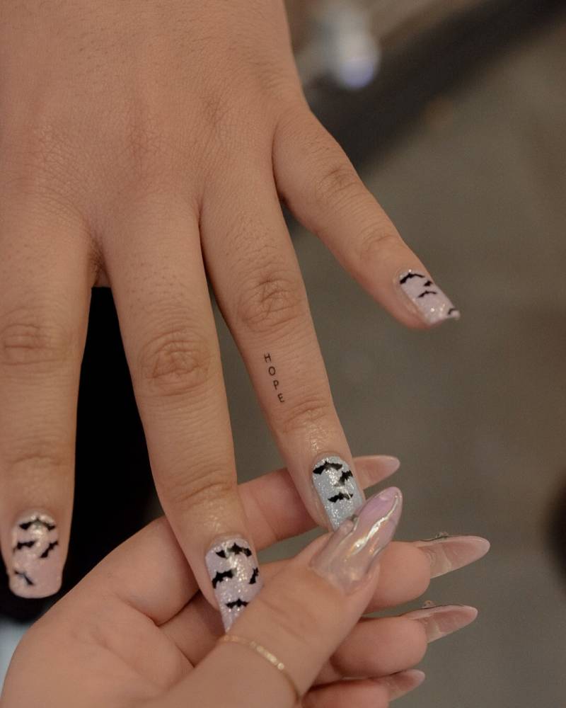 Micro lettering tattoo of the word "hope" done on the finger.