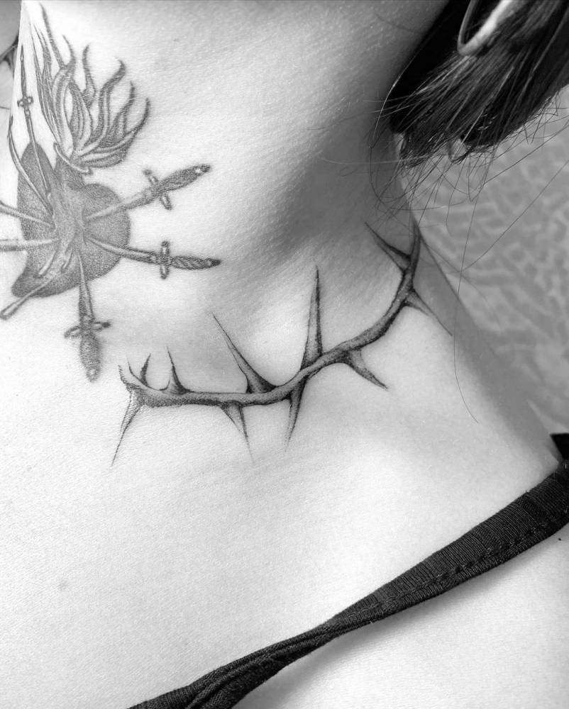 Flaming heart + thorns tattoo on the neck