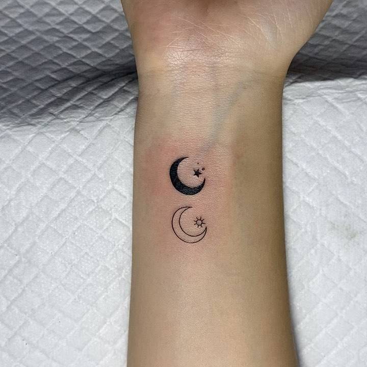 Sun and moon tattoo on the wrist