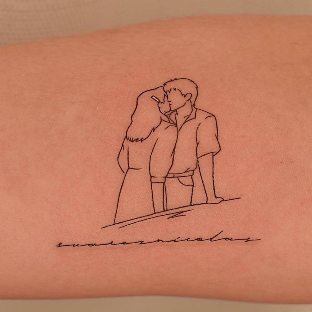 Fine line kiss tattoo on the inner forearm