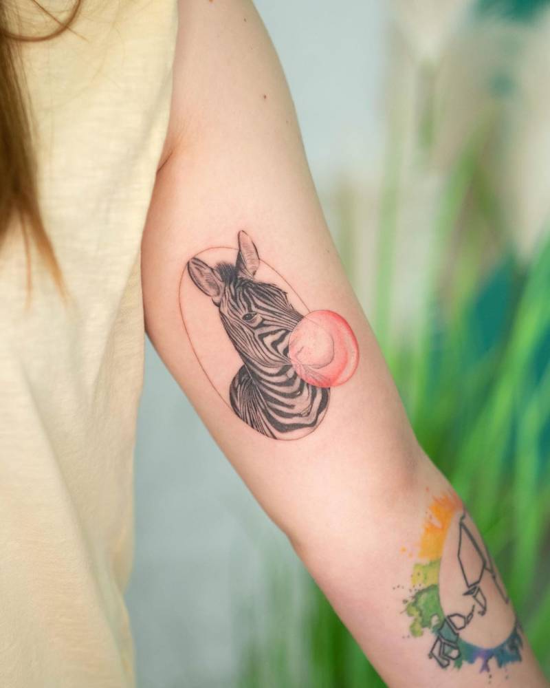 Zebra bubble gum tattoo on the inner arm