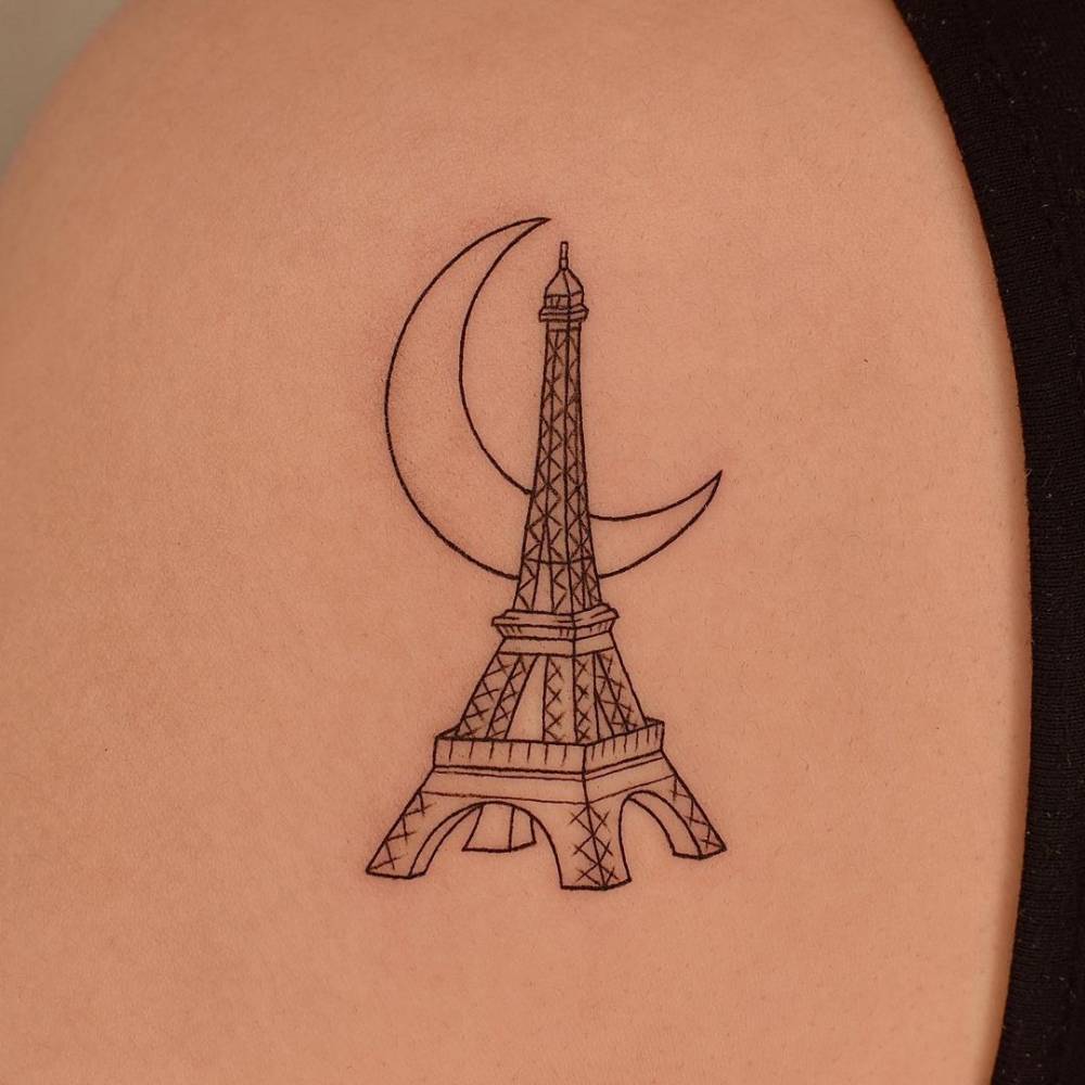Fine line Eiffel Tower tattoo on the shoulder