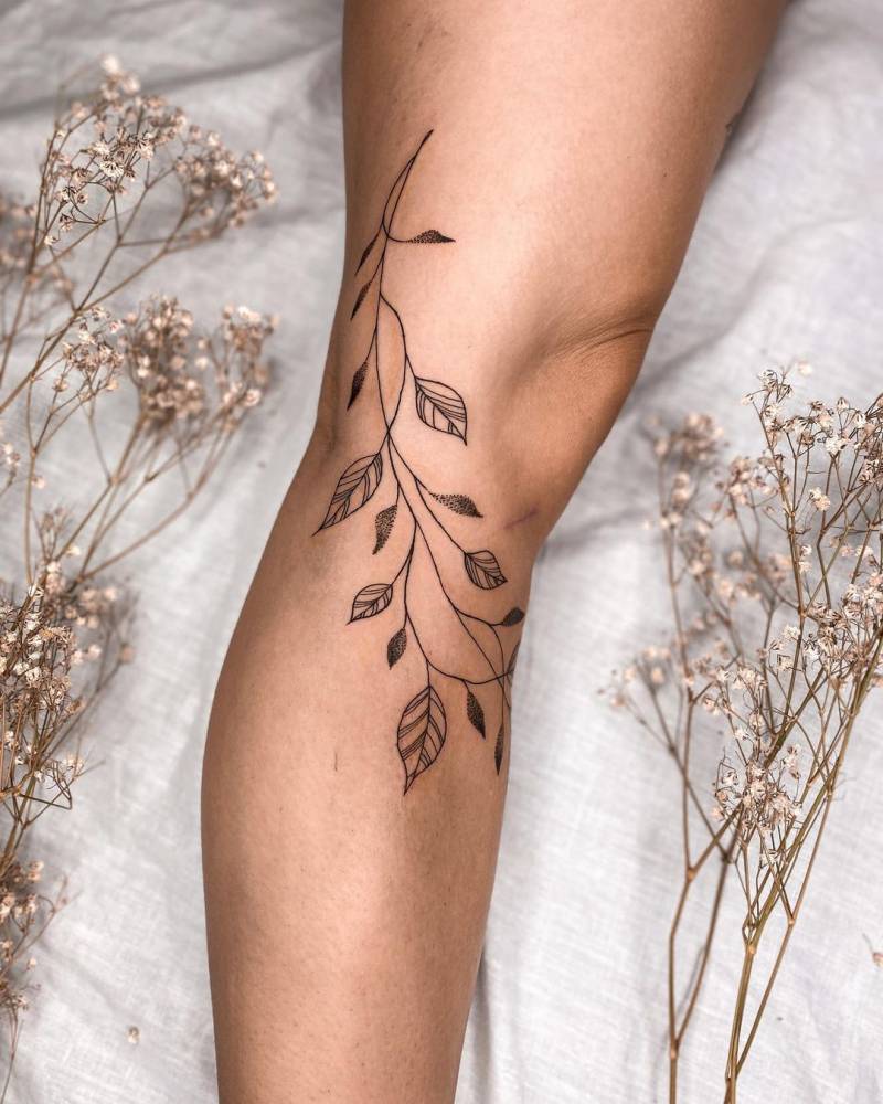 Line art leaves tattoo on the leg
