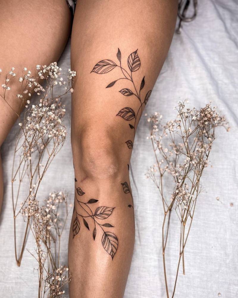 Line art leaves tattoo on the leg
