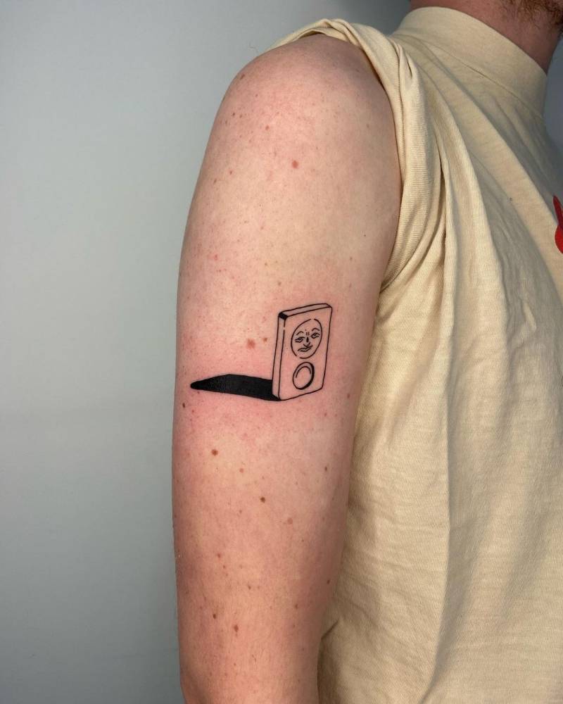 Rummikub tattoo on the upper arm