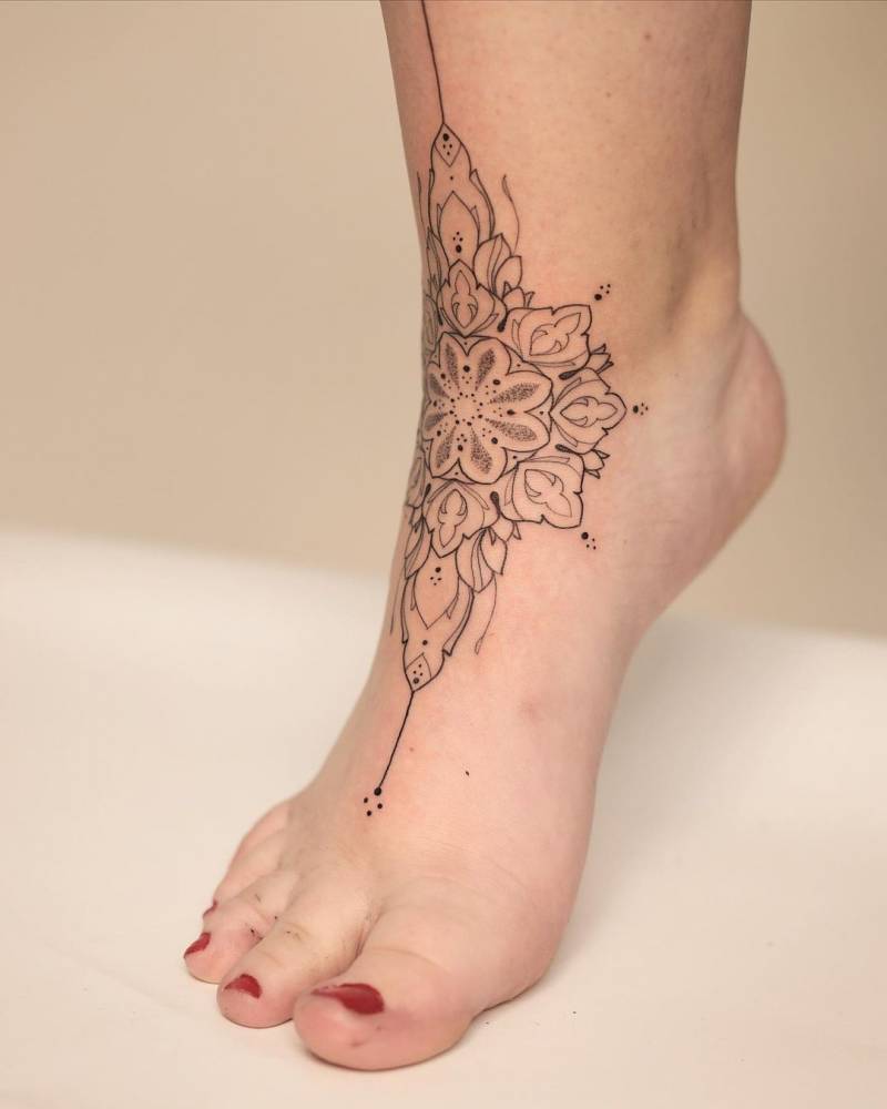 Fine line mandala tattoo on the foot.
