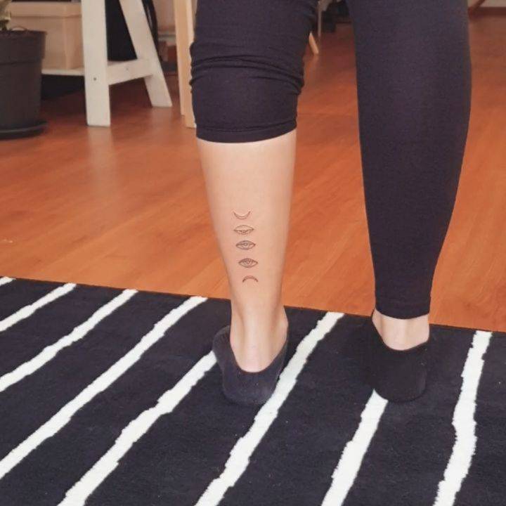 Line art moon phases tattoo on the achilles.