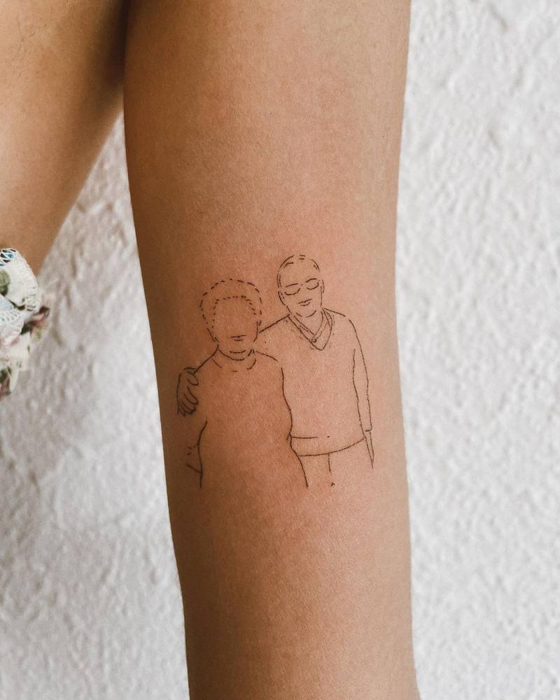 Minimalist grandparents tattoo on the inner arm.
