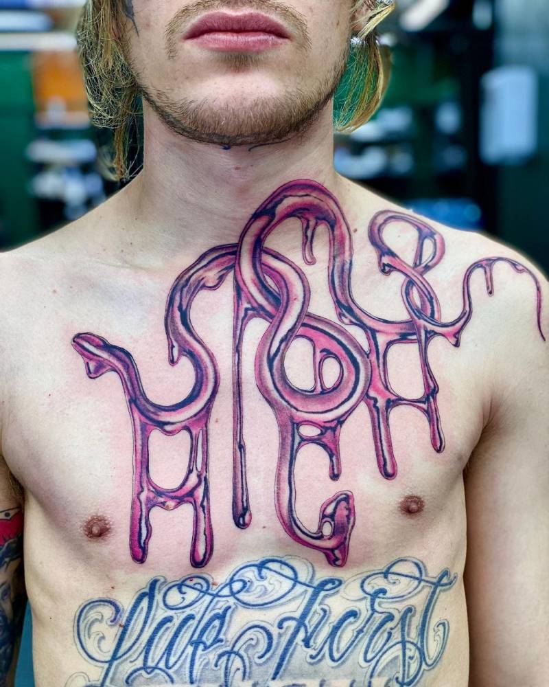 Metallic effect "HIGH" lettering tattoo on the chest.