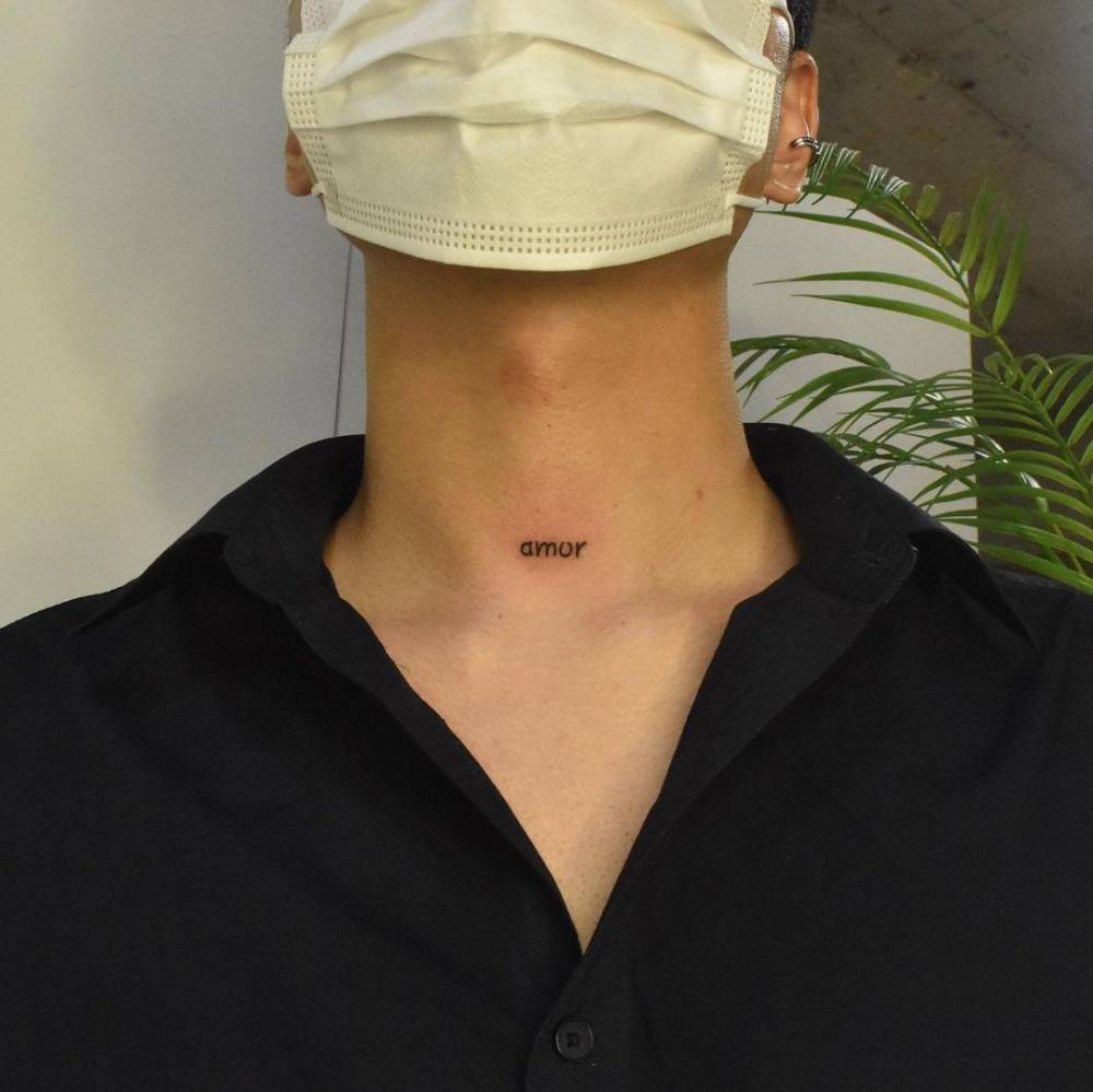 "Amor" lettering tattoo on the neck.