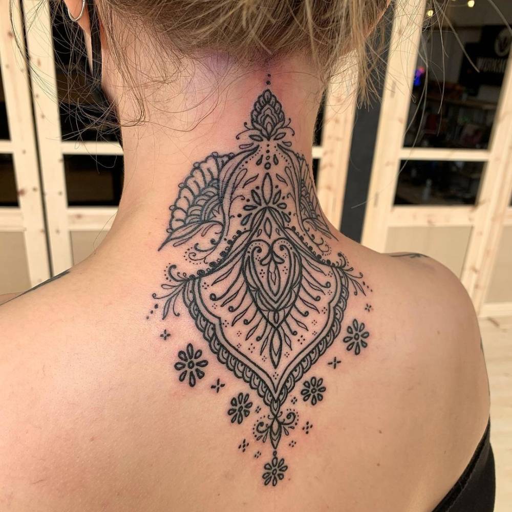 Ornamental tattoo on the back of the neck.