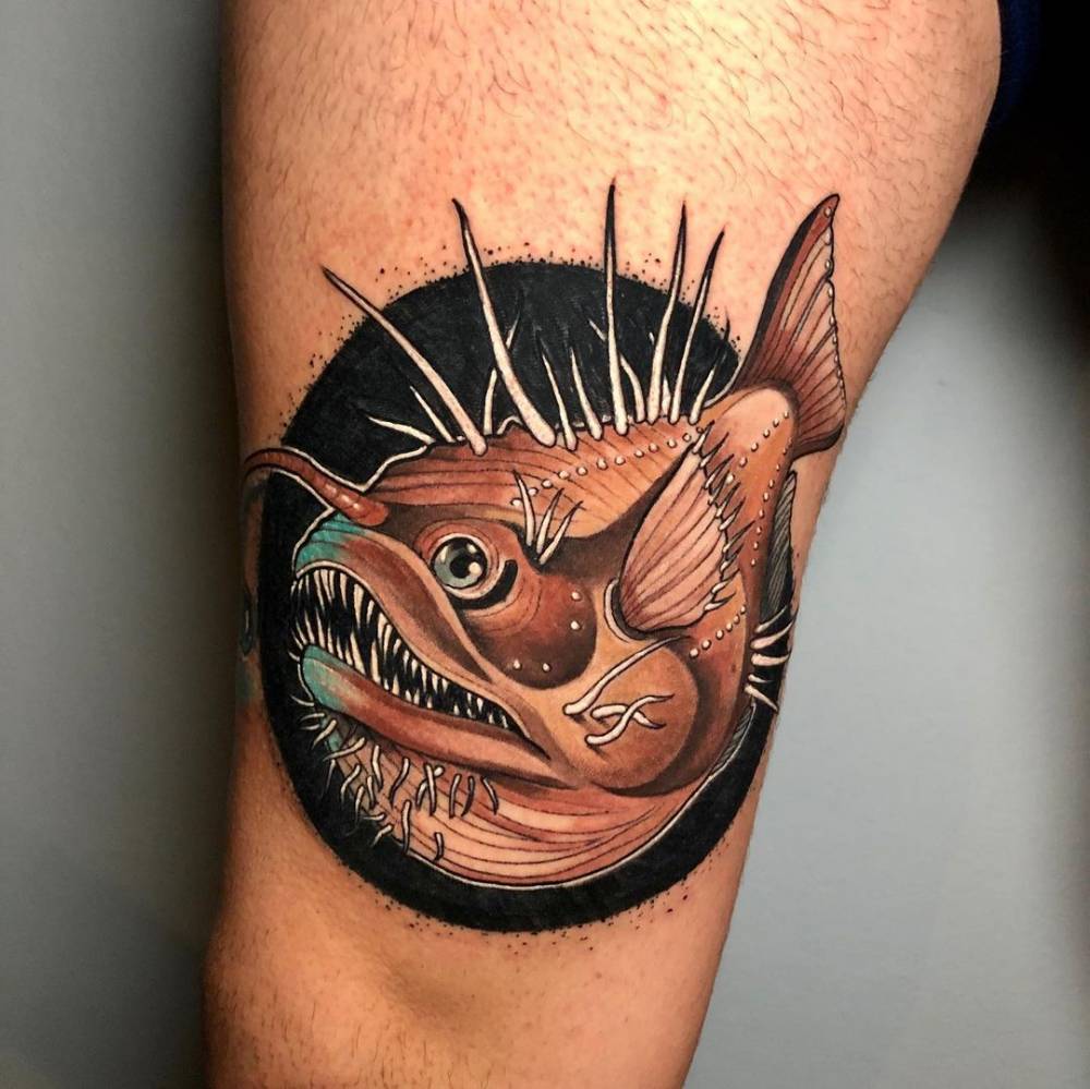Neotraditional anglerfish tattoo on the thigh.