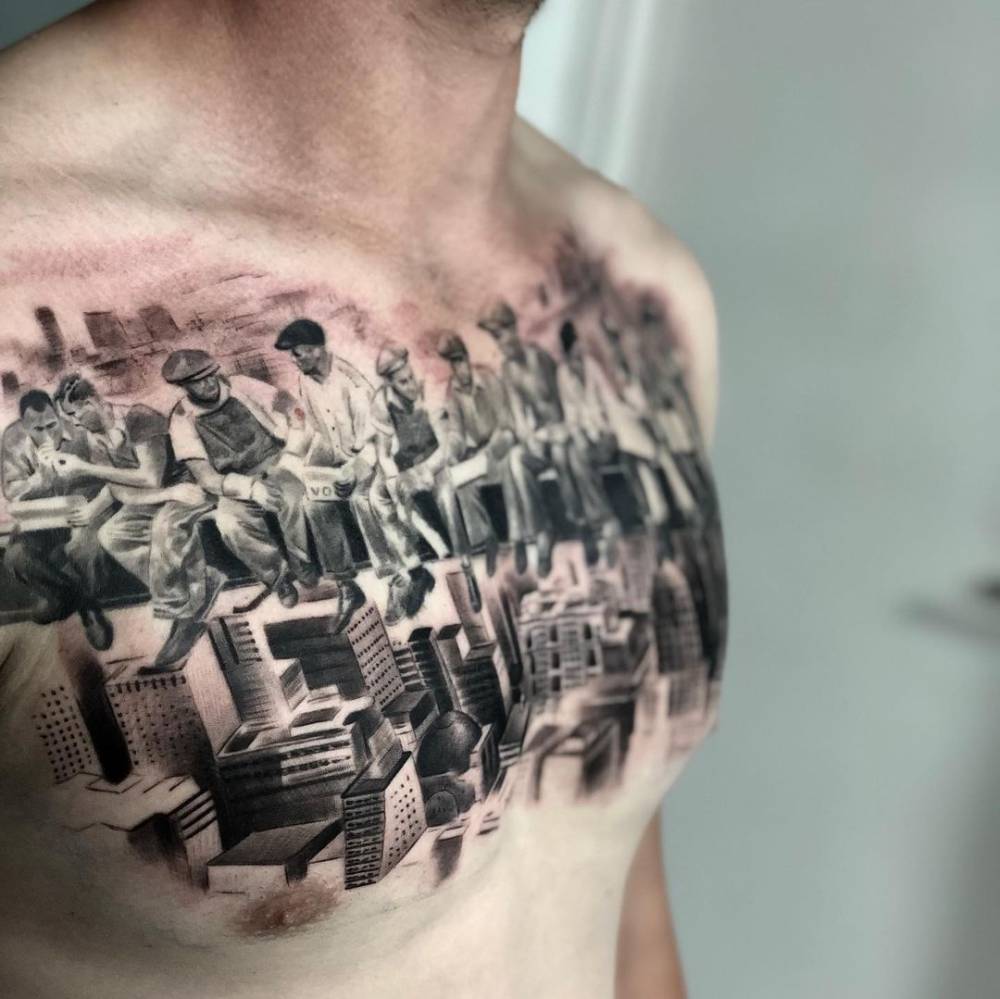 Black and grey “Lunch atop a Skyscraper” tattoo on the chest.