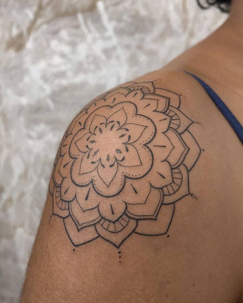 Mandala tattoo on the shoulder.