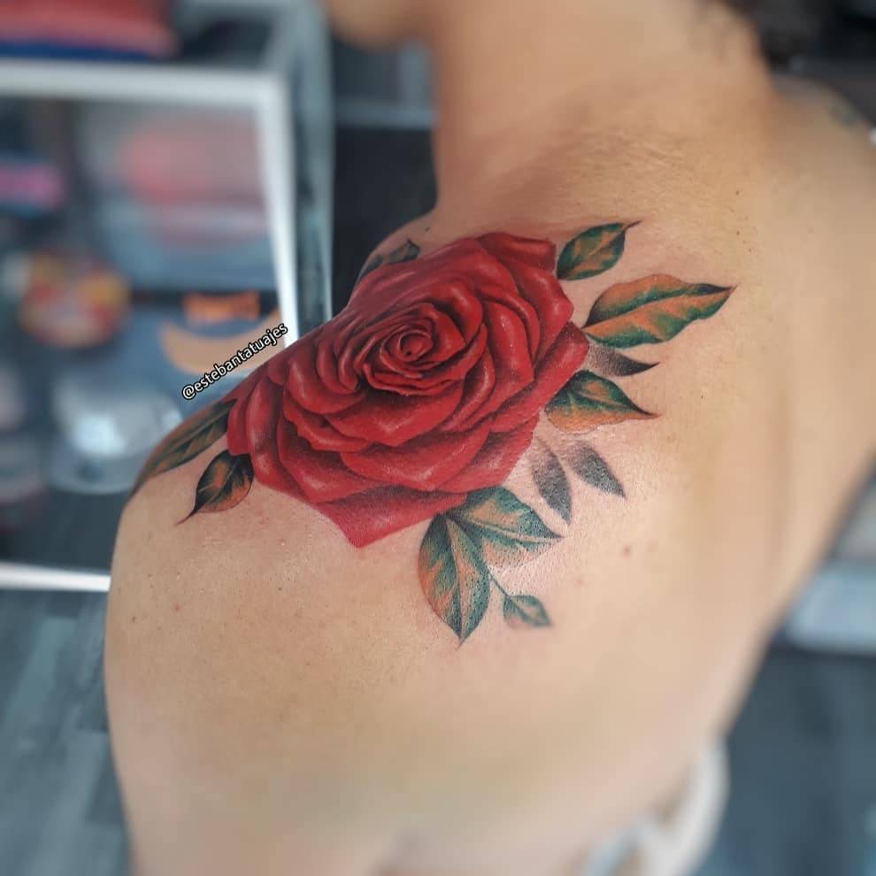 Realistic rose head tattoo on the shoulder.