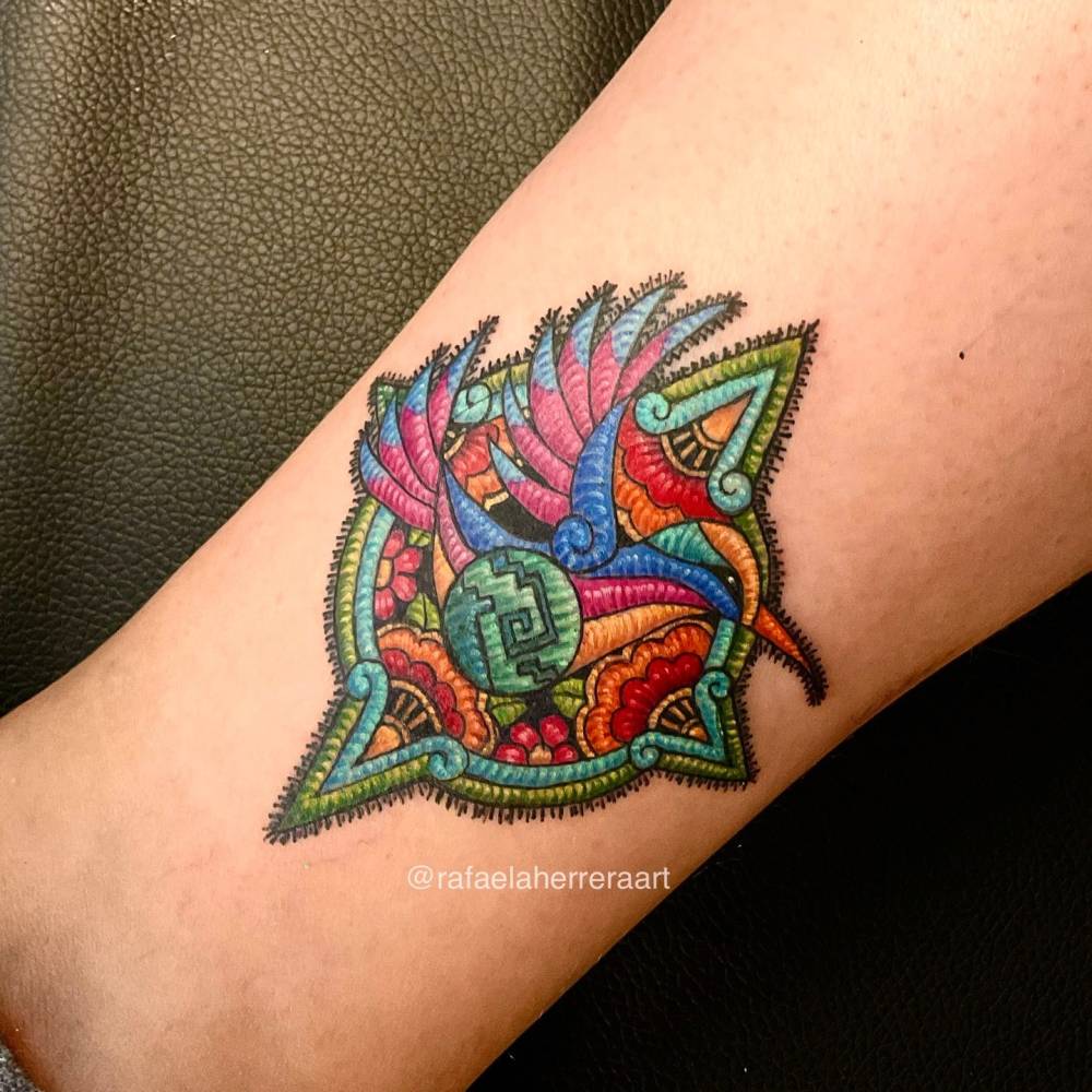 Hummingbird patch tattoo in embroidery style located on the wrist.