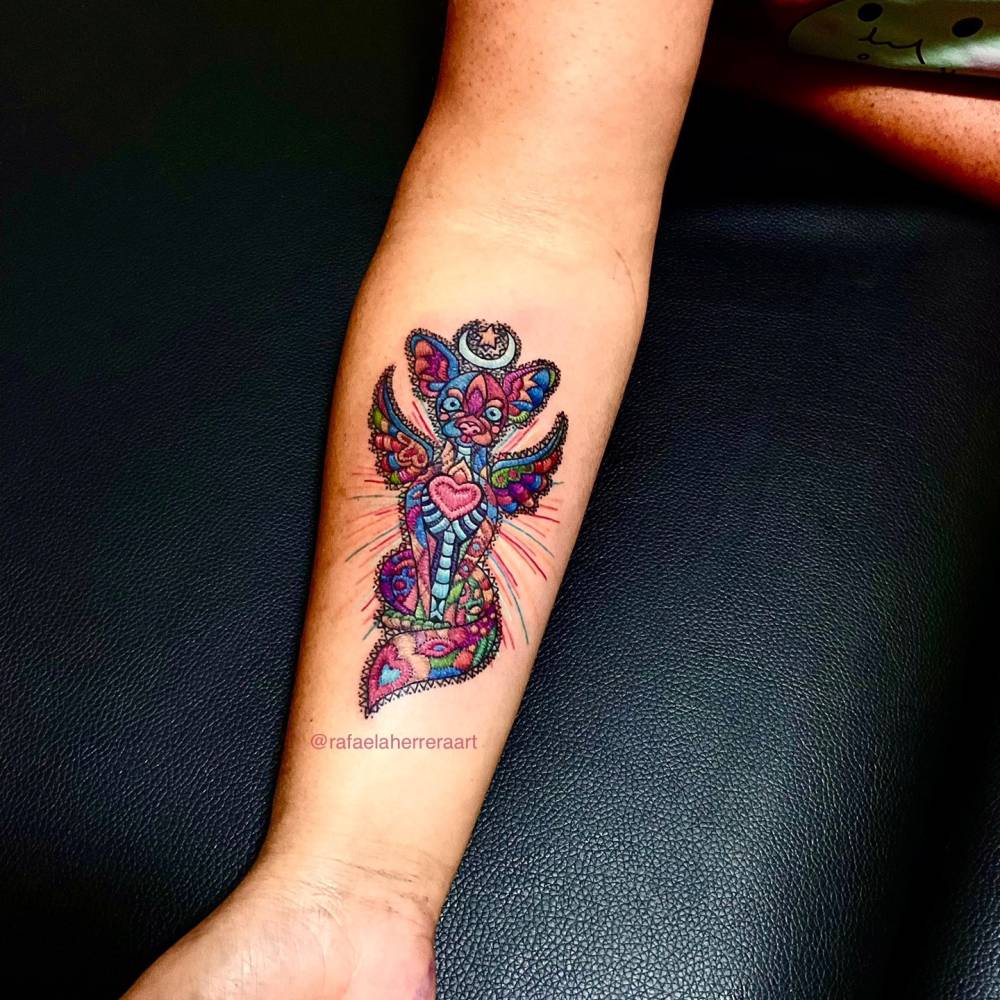 Mexican embroidery Chihuahua patch tattoo located on the inner forearm.