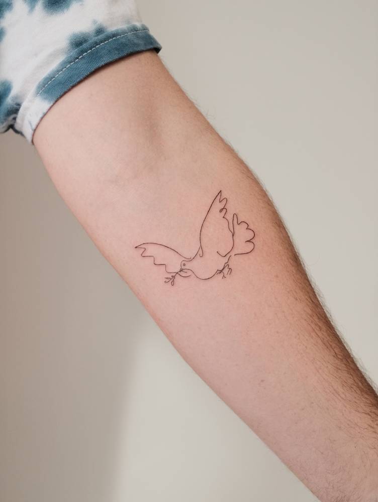 Dove tattoo placed on the inner forearm, fine line style.
