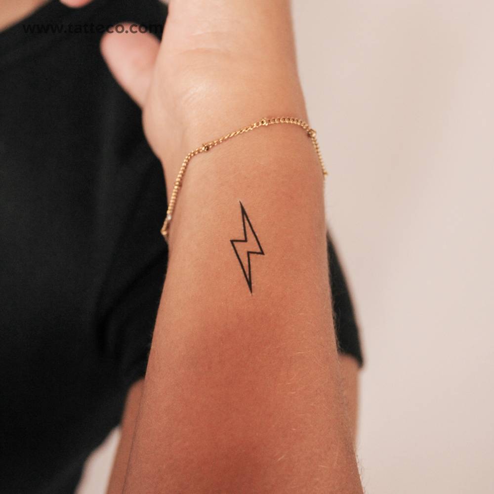 Lightning bolt outline 2-week temporary tattoo located on the wrist.