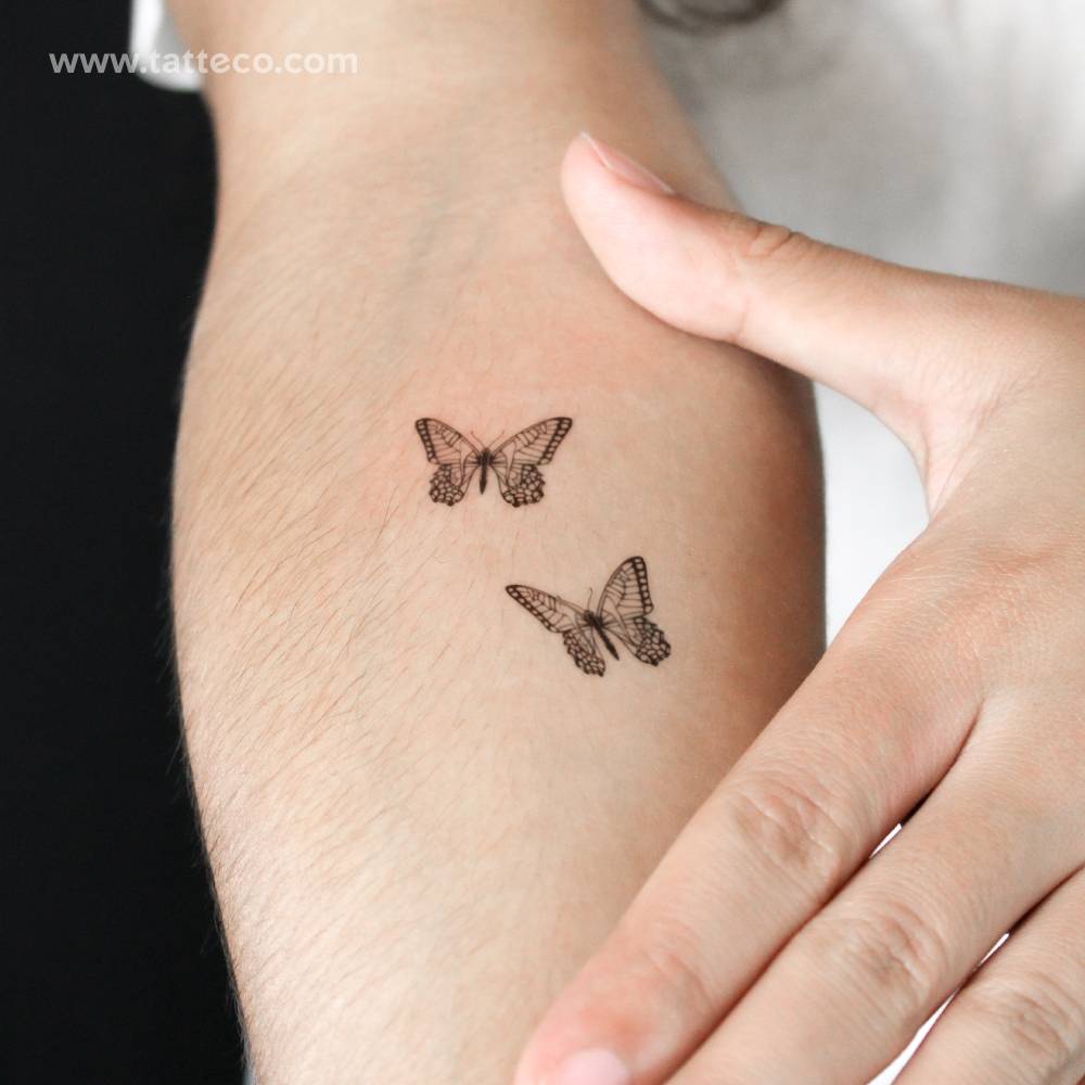 Butterfly couple semi-permanent tattoo located on the inner forearm.