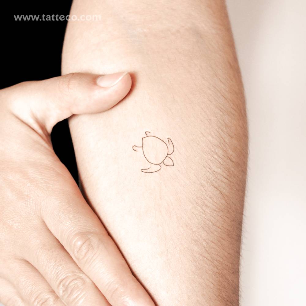 Minimalist turtle semi-permanent tattoo located on the inner forearm.