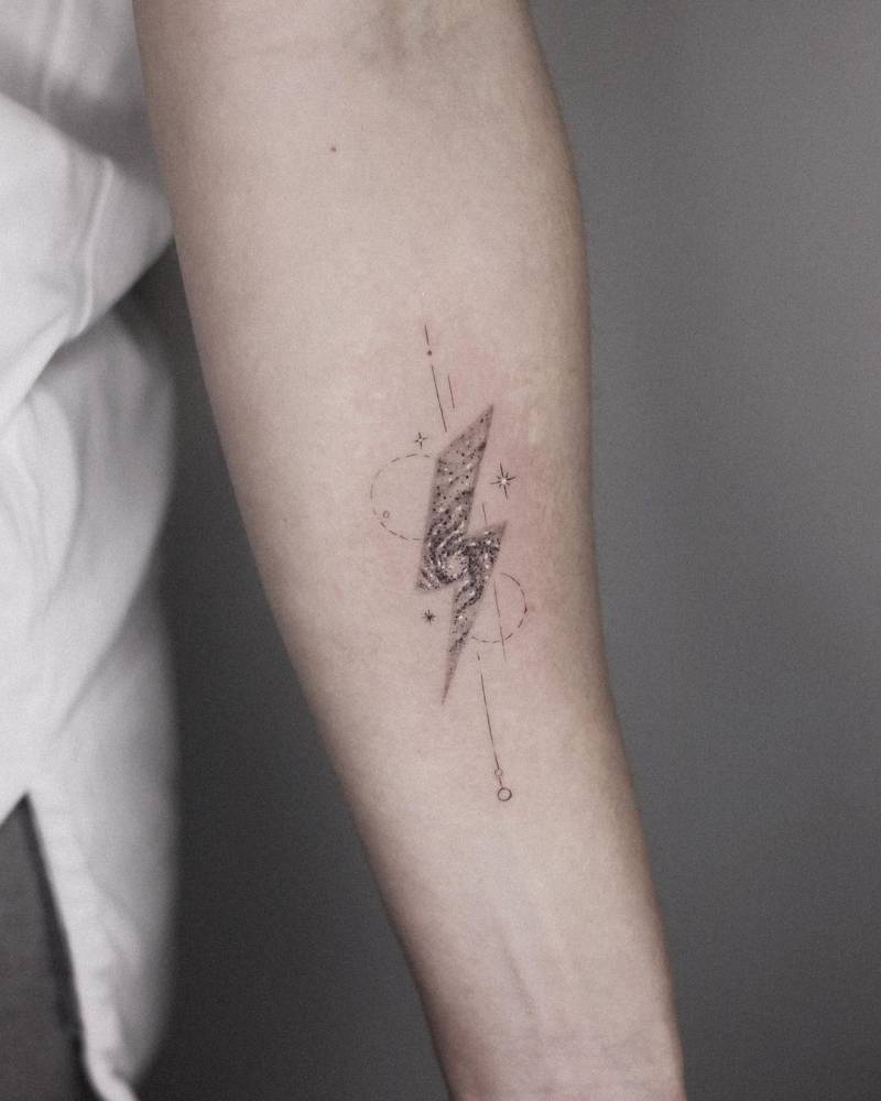 Galaxy in a lightning bolt tattooed on the inner forearm.
