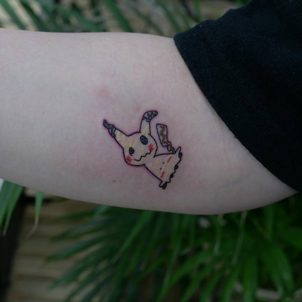 Mimikyu tattoo located on the inner forearm.
