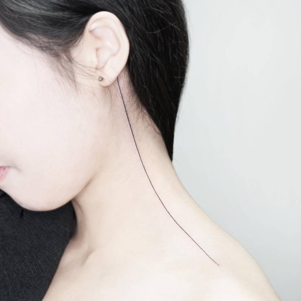 Minimalistic line tattoo located on the neck.