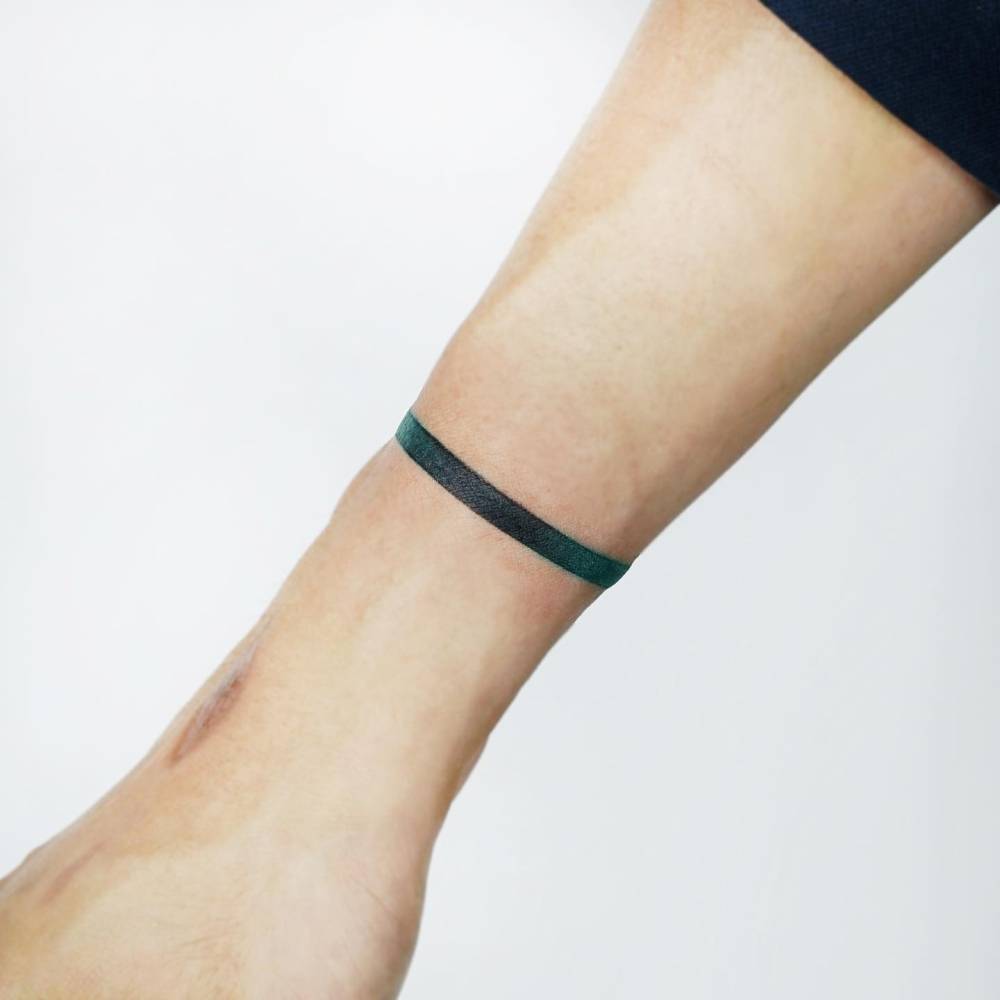 Green spectrum wristband tattoo.