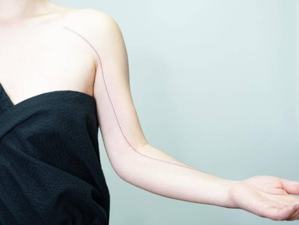 Minimalistic line tattoo located on the arm.