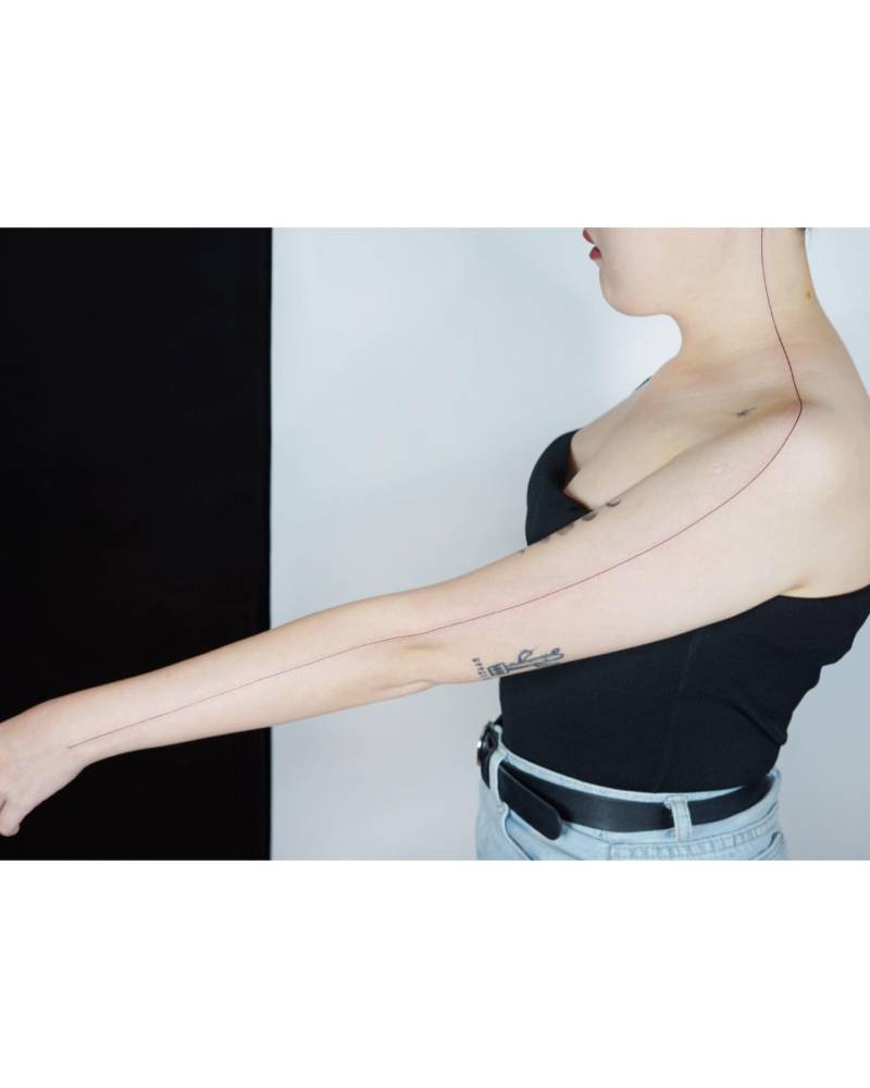 Minimalistic style line tattoo located on the neck and arm.