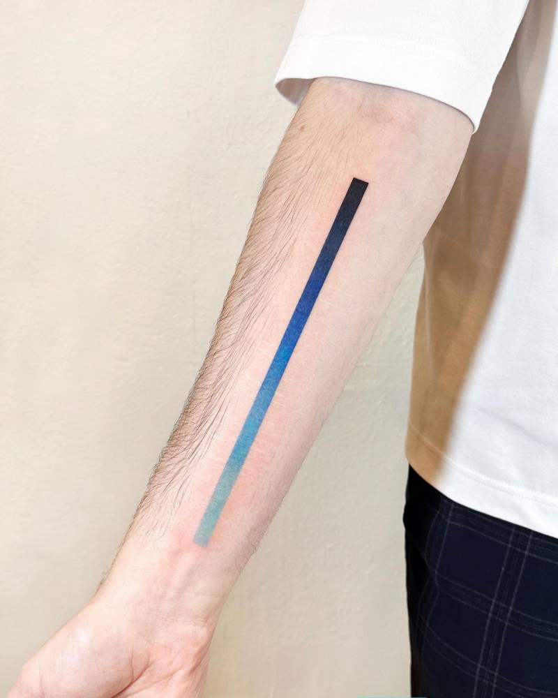 Spectrum line tattoo located on the inner forearm.