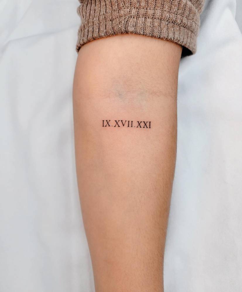 Date in roman numeral tattooed on the inner forearm.