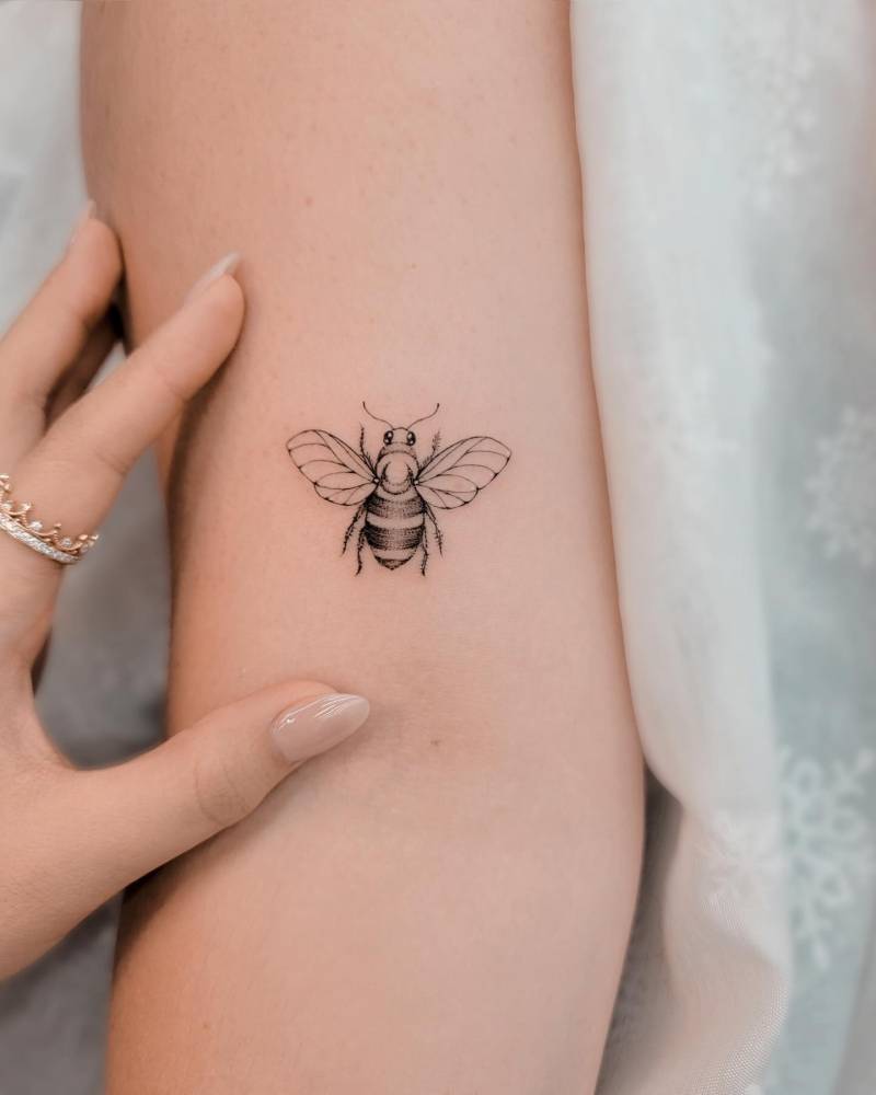 Illustrative style bee tattoo done on the bicep.