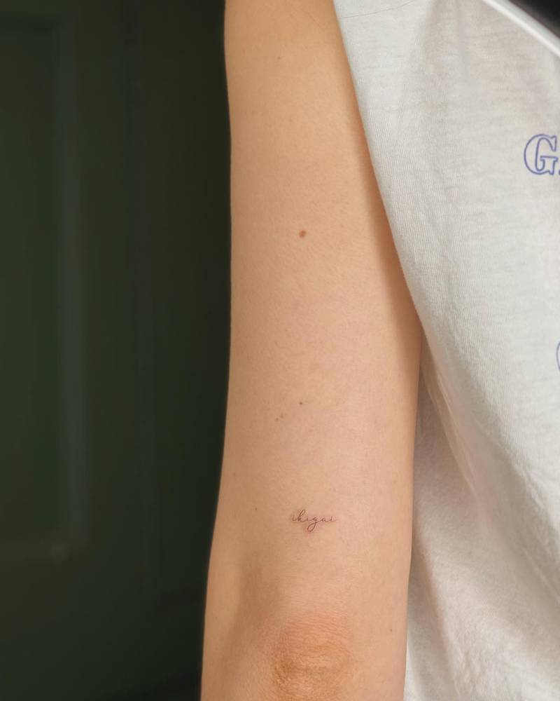 Word "ikigai" lettering tattoo located on the tricep.